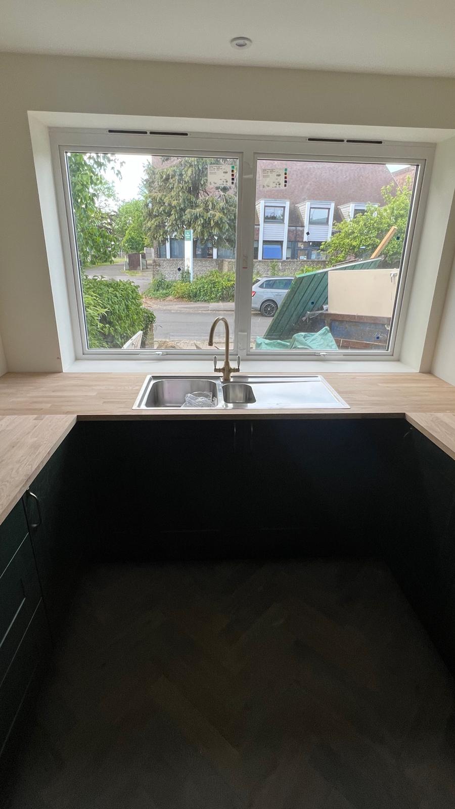 Kitchen sink under window with brass tap
