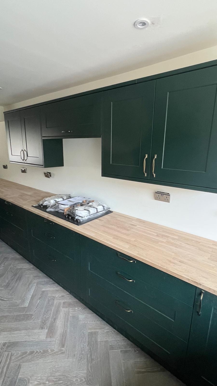Gas hob, oak counter and shaker doors — complete.
