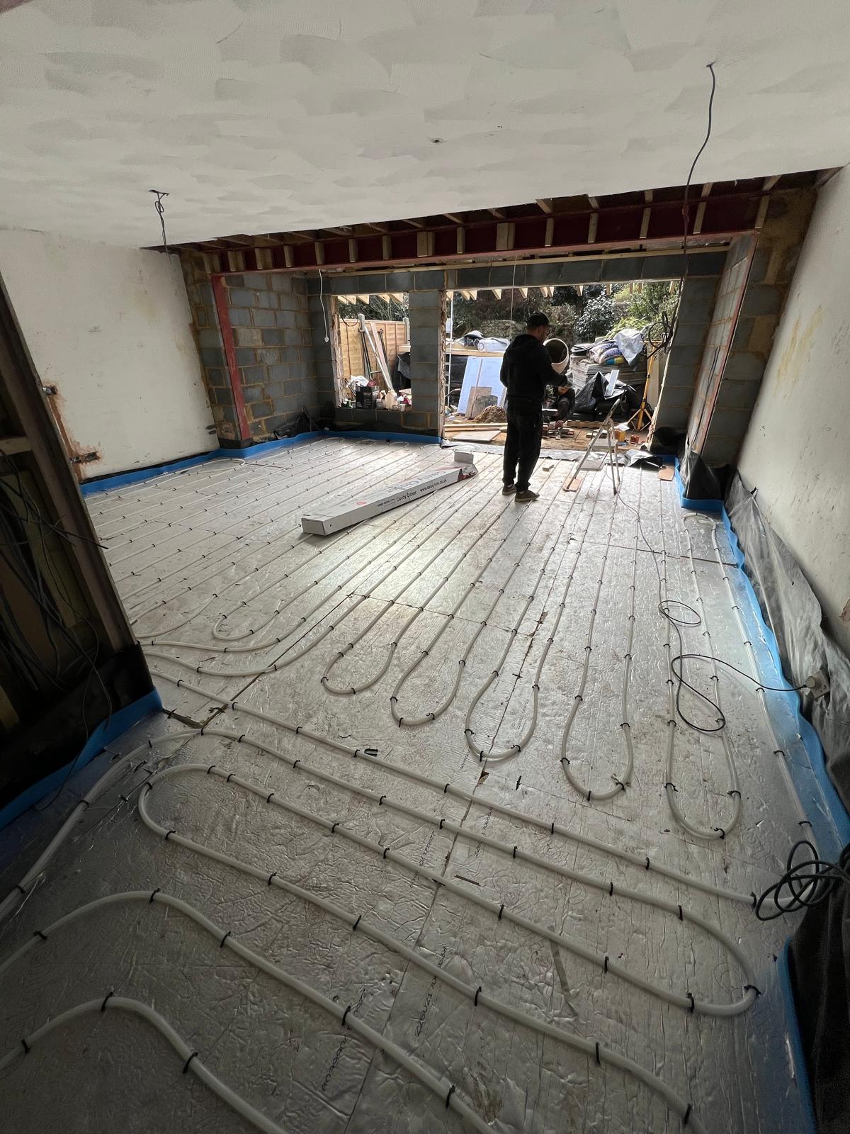 Underfloor heating pipework being laid on site