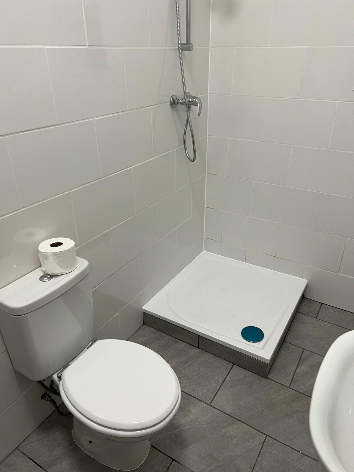 Newly finished bathroom with grey floor tiles